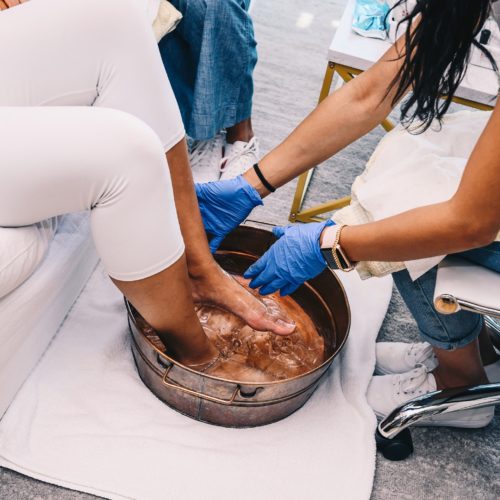 Long Island City, NY 7/19/2020 Genesis Aguirre of Green Spa perform a pedicure on Ashley Lauren Barton in her apartment. Photograph by Nina Westervelt.