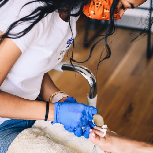 Long Island City, NY 7/19/2020 Genesis Aguirre of Green Spa perform a pedicure on Ashley Lauren Barton in her apartment. Photograph by Nina Westervelt.